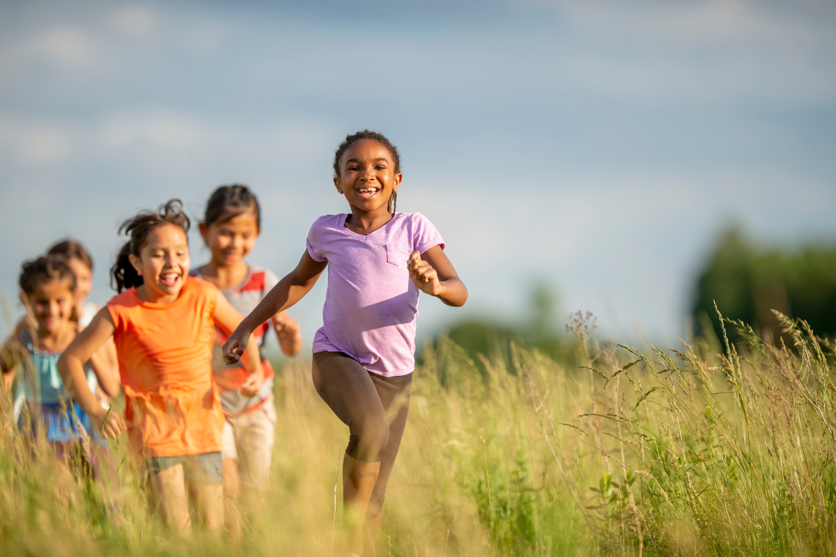 kids running through open field 