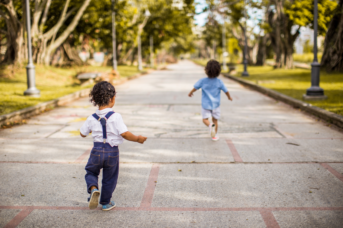 kids running down a path in a park